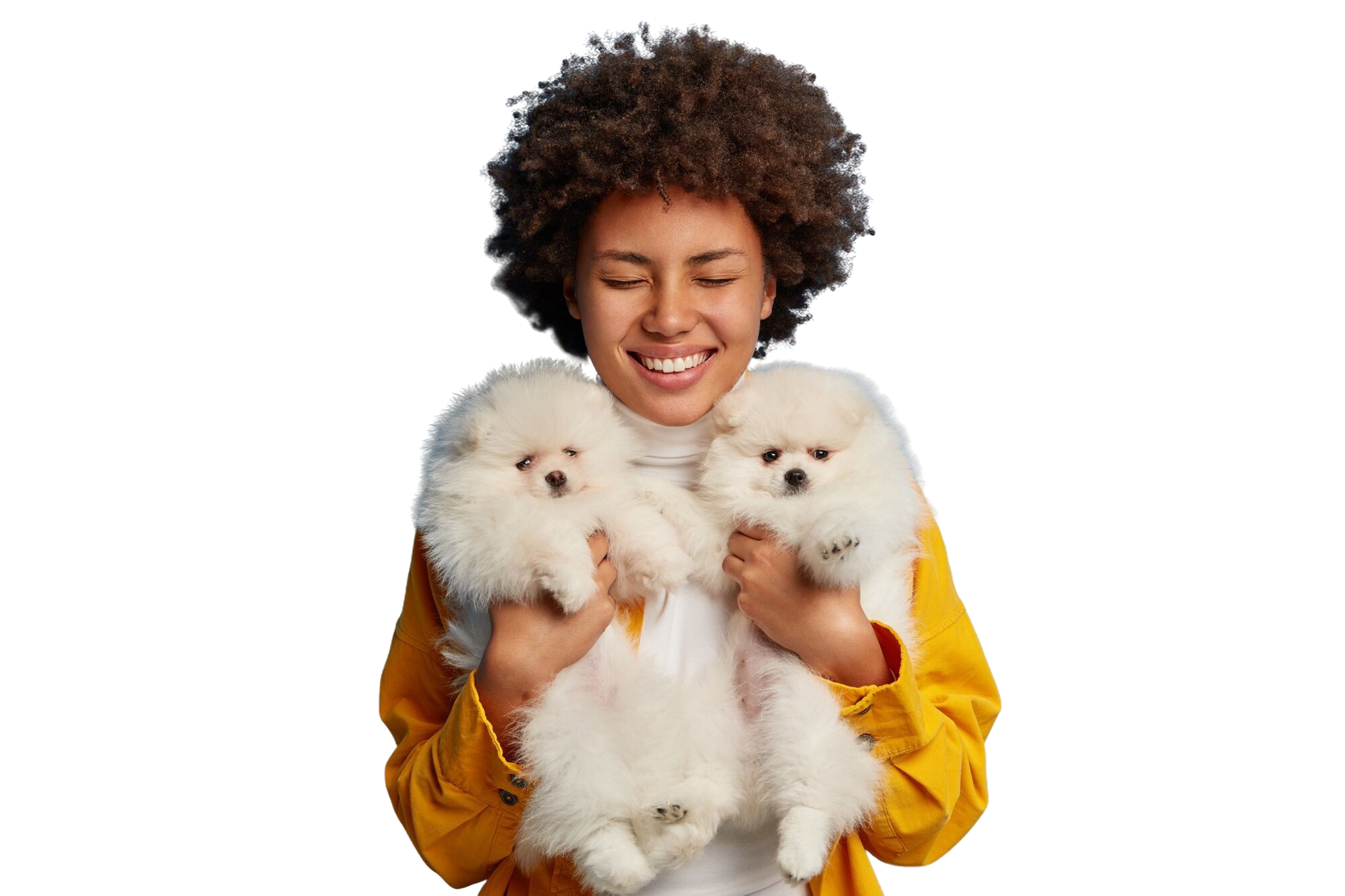 A happy pet owner smiling while holding two fluffy white puppies